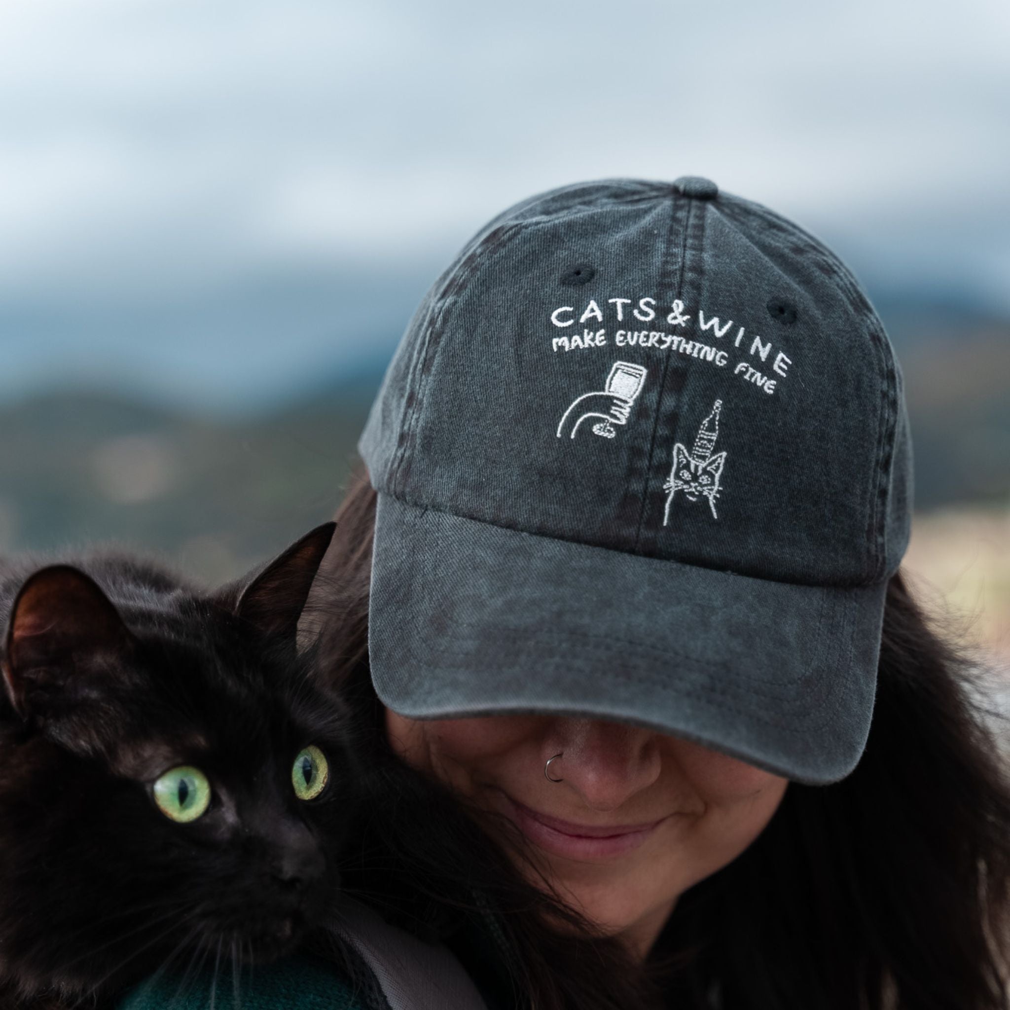 black-denim-cap-cats-wine-logo-wearing-woman-closeup.jpg